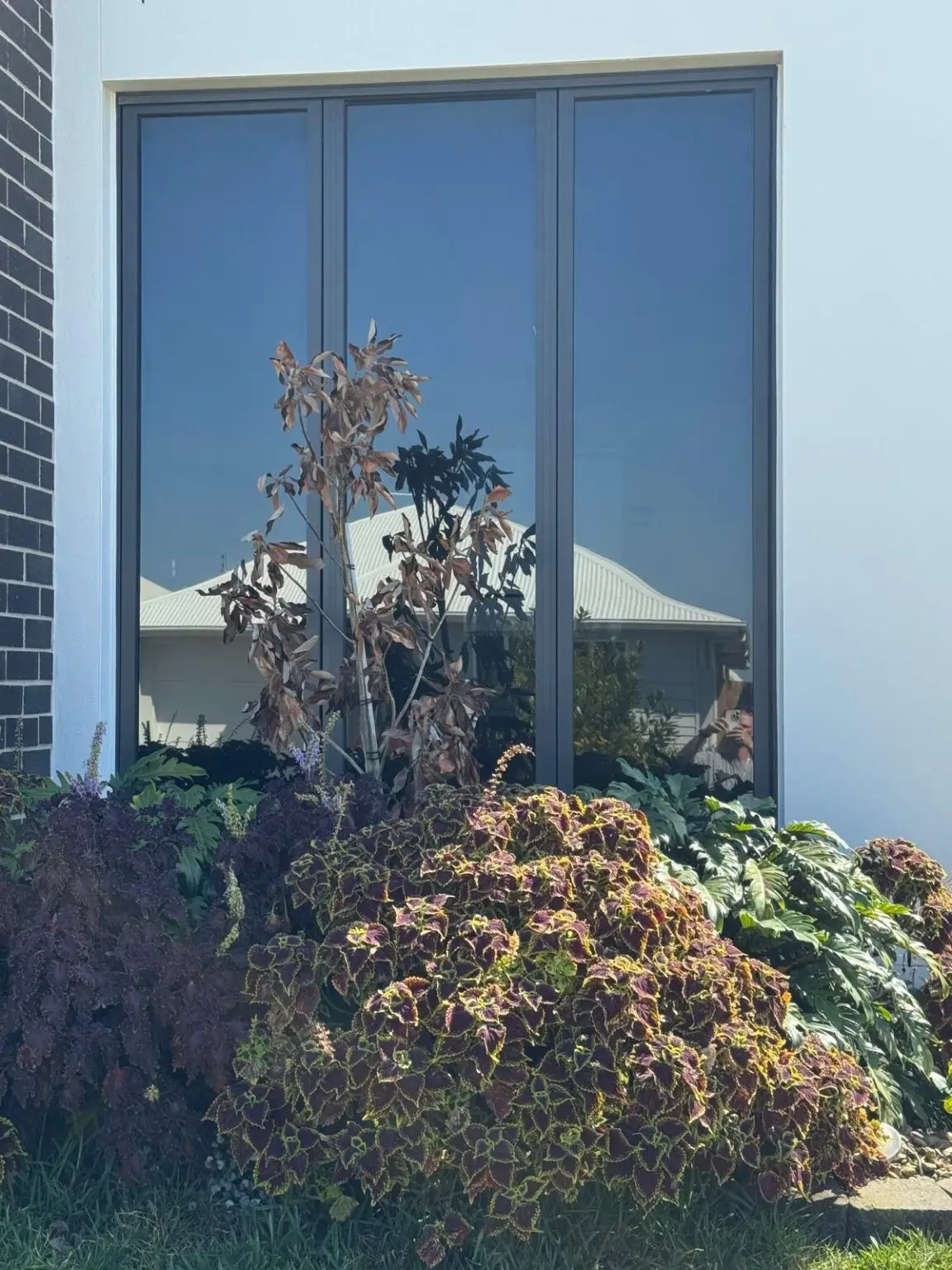 Reflective solar control window film on large residential windows reducing heat and glare