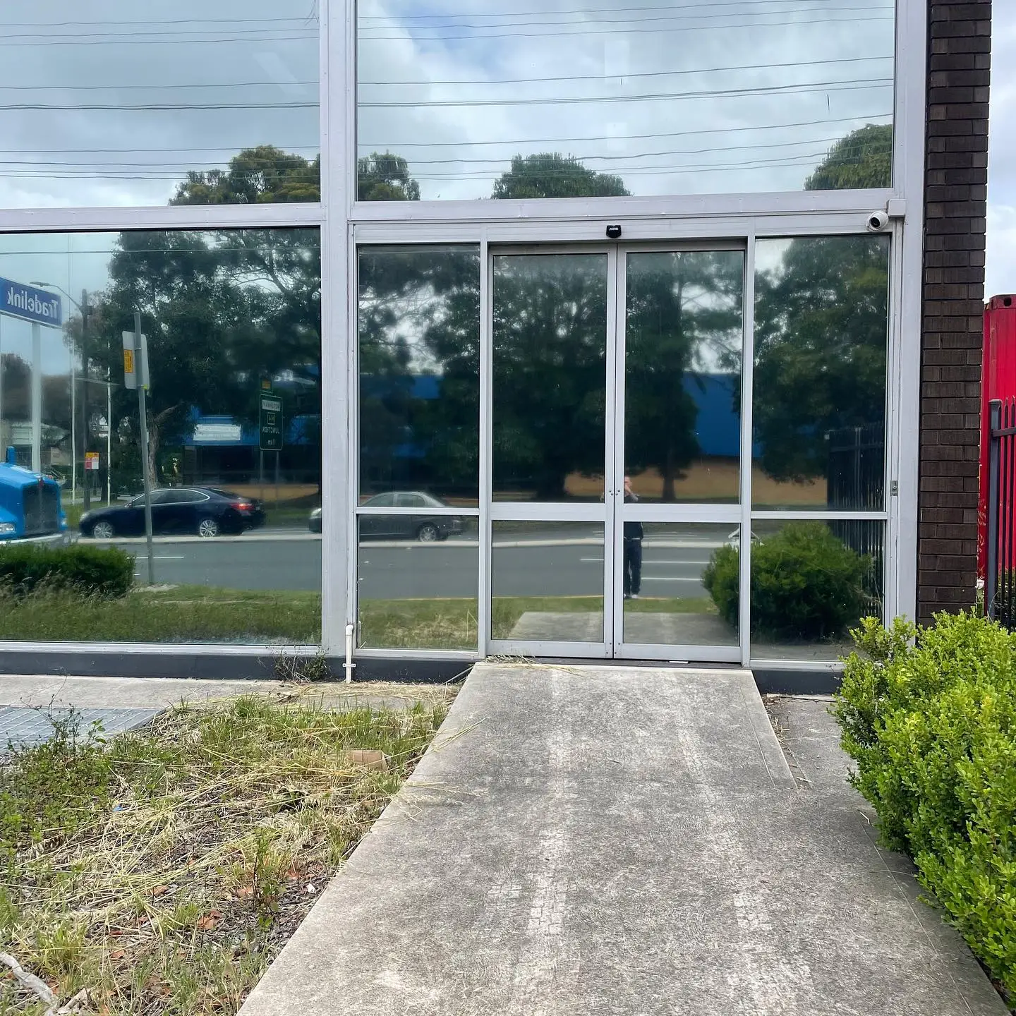 Reflective one-way window film on the windows of a commercial building in Nirimba
